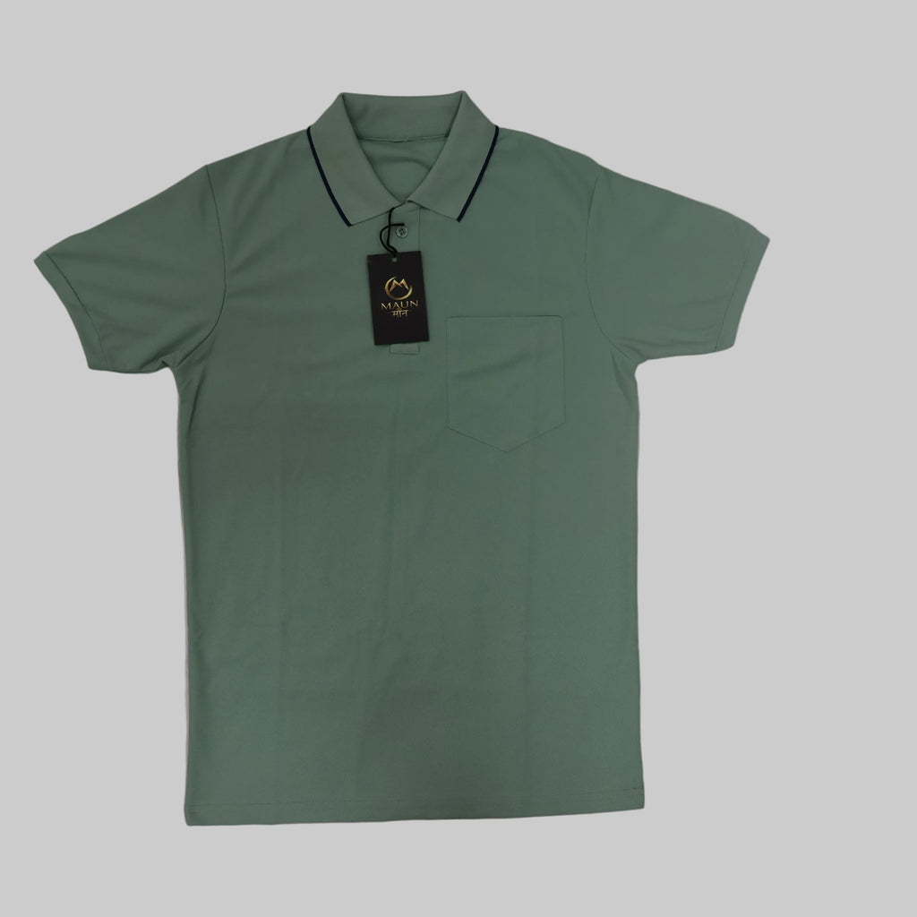Green polo shirt with a tag on a tiled floor